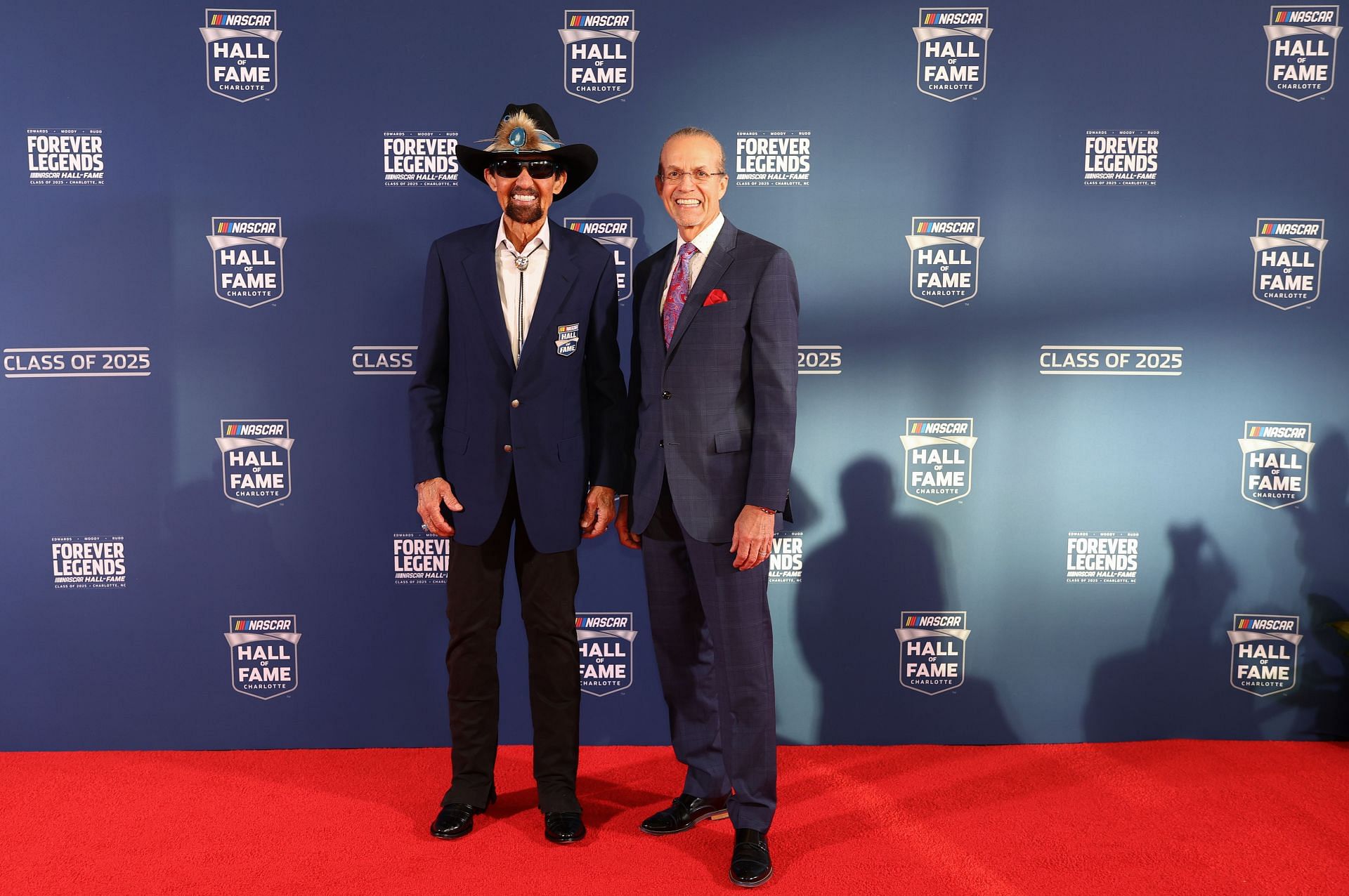 Richard Petty (L) and his son Kyle Petty pose on the red carpet prior to the 2025 NASCAR Hall of Fame Induction Ceremony - Source: Getty